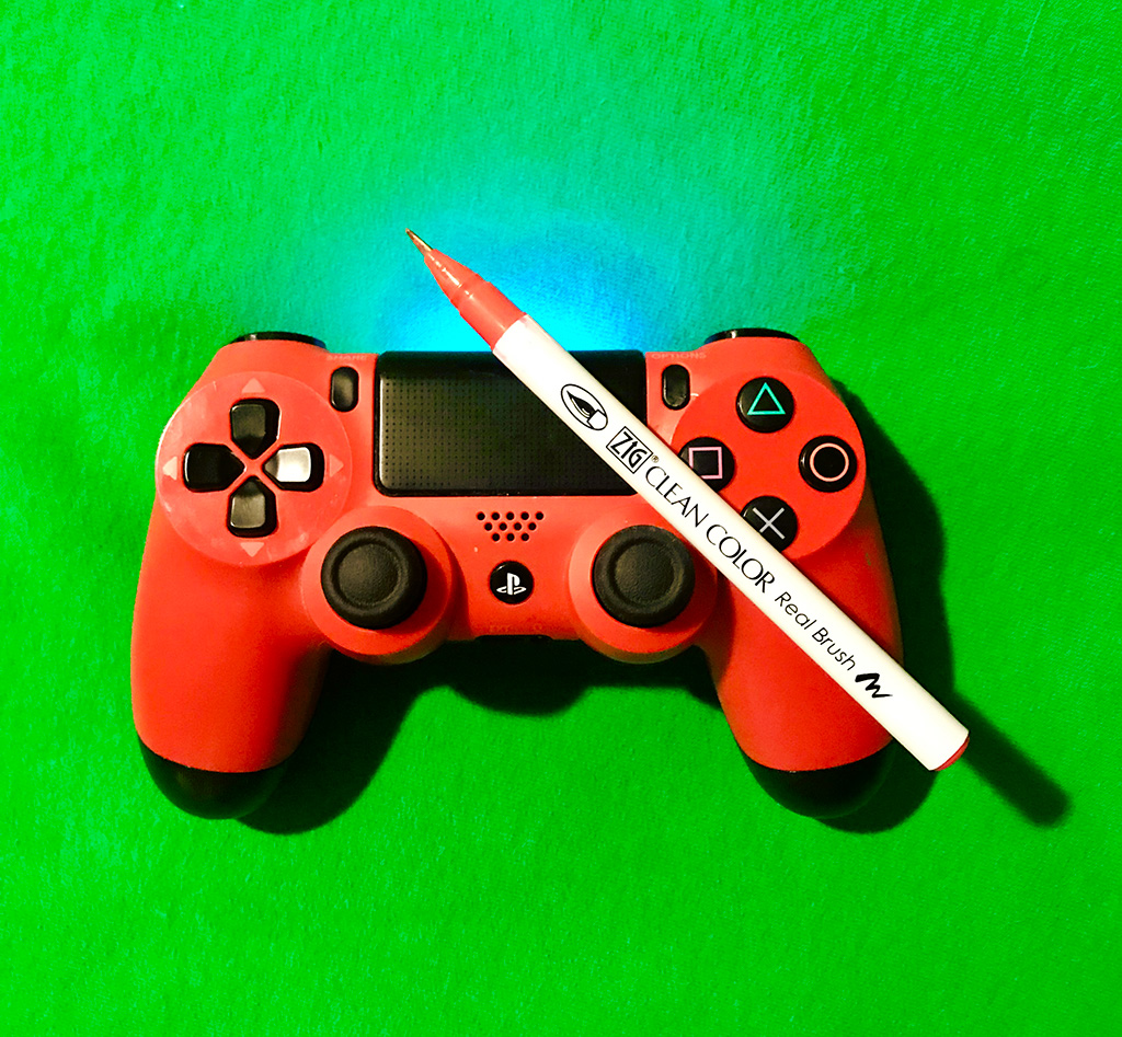 Photo of a Playstation 4 controller with a paintbrush.
