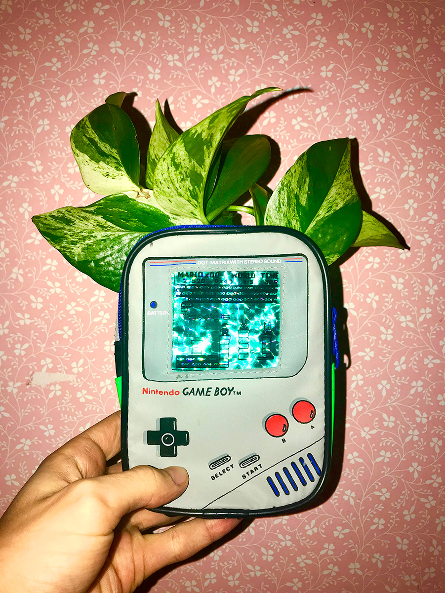 Illustration of bark and leaves in the back of a Gameboy.
